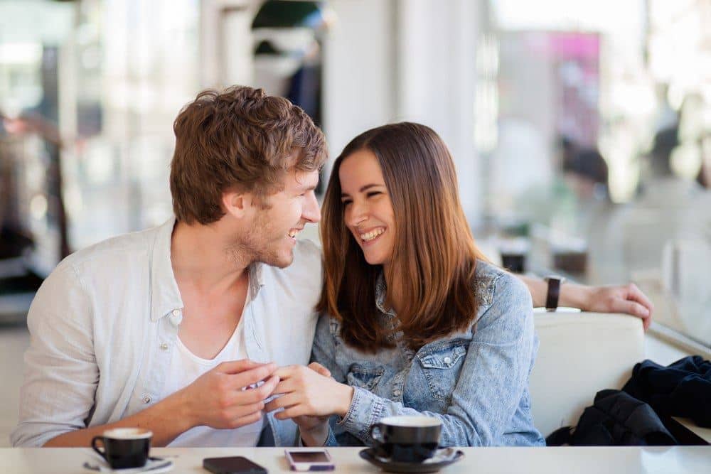 Woman and man talking across a table