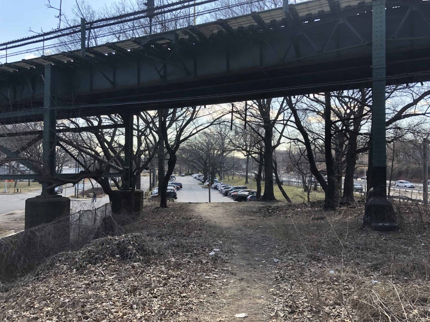 train overpass over a road and forest pedestrian trail