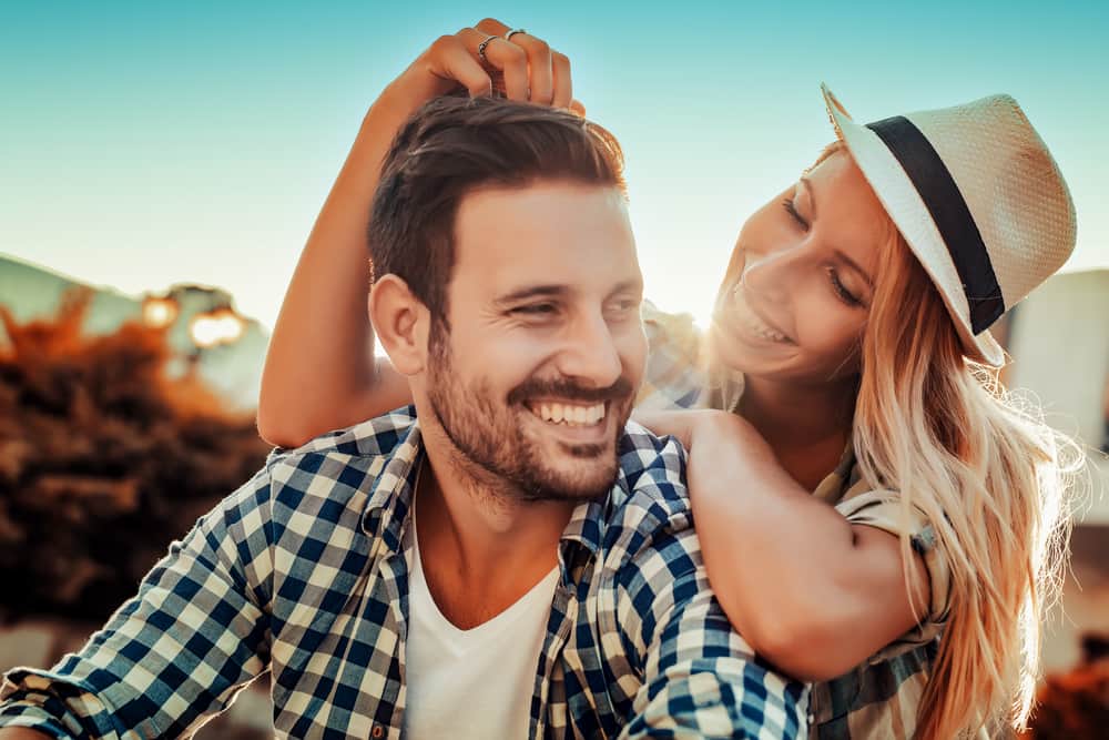 Couple standing close together outdoors