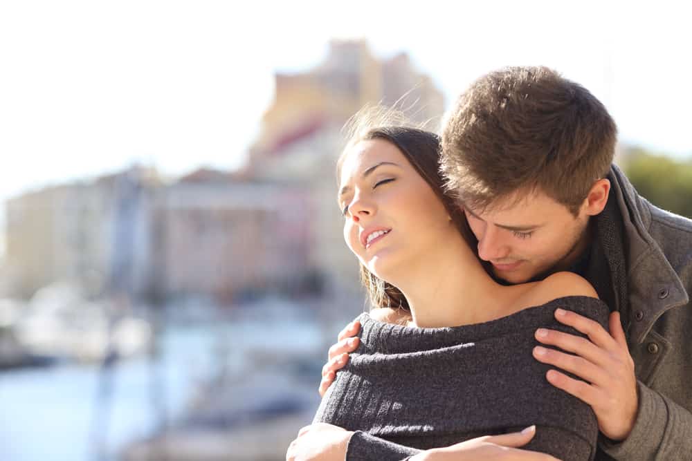man smelling a sexy woman