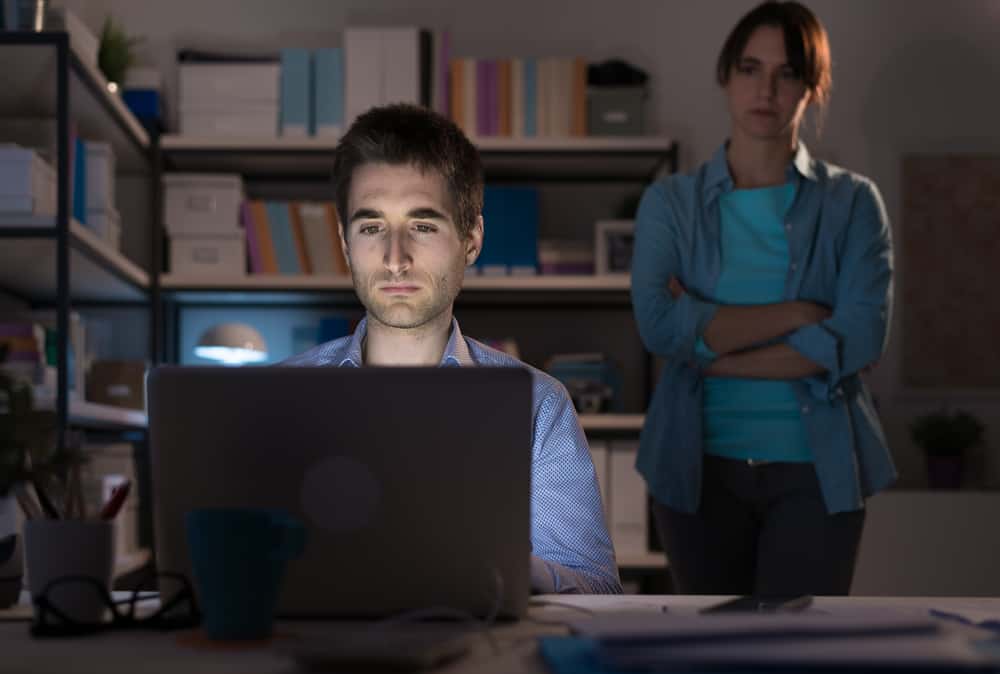 man working ignoring wife