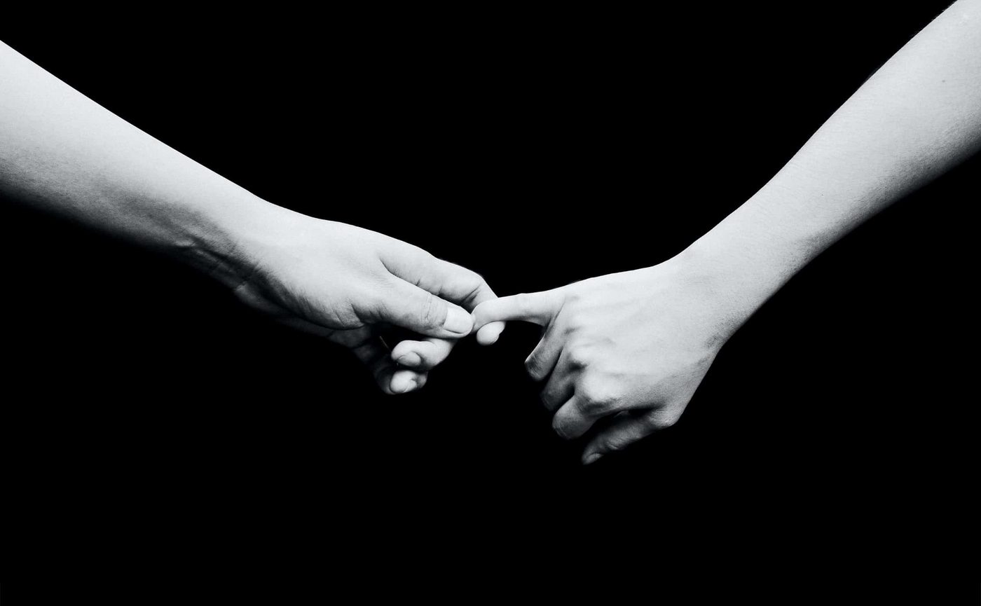 two persons holding hands