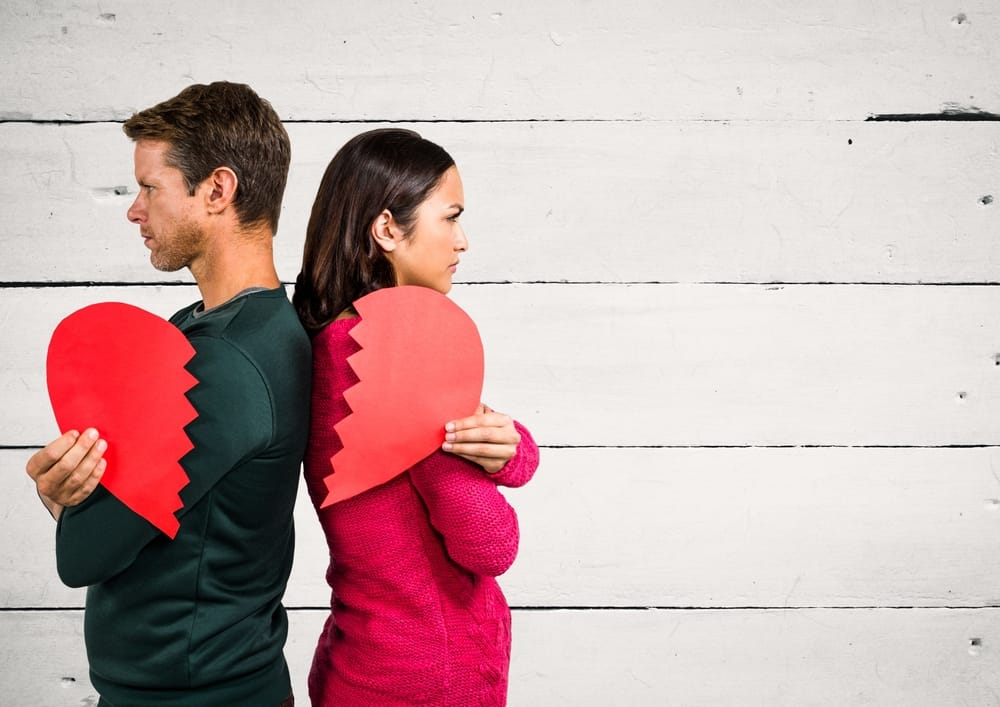 couple broke up holding half heart each