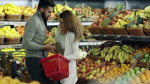 Two young people bumping into each other at the Supermarket.