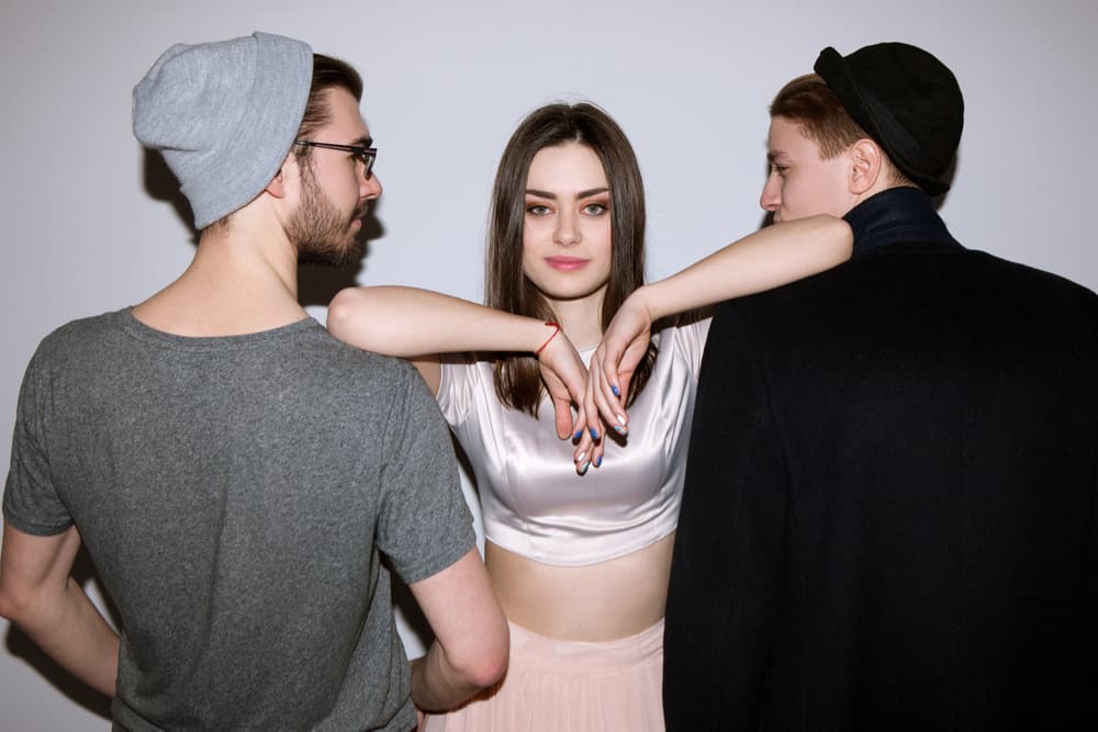 2 guys 1 girl in the middle smiling