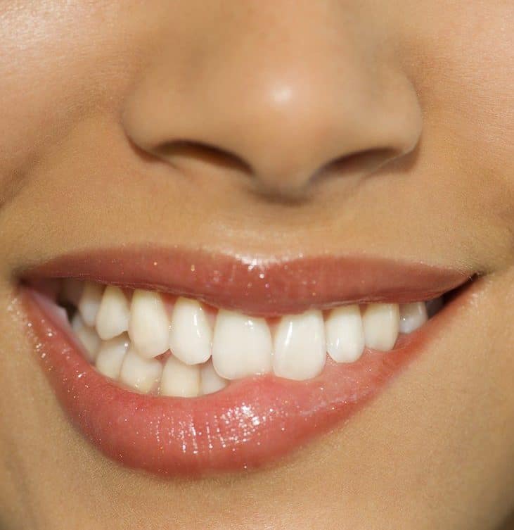 close up on woman's mouth biting her lip
