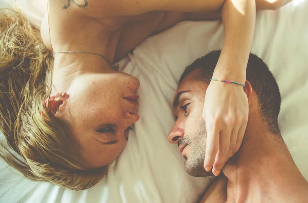 man and woman in bed