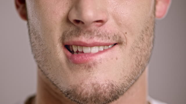 Young Caucasian man biting his lip