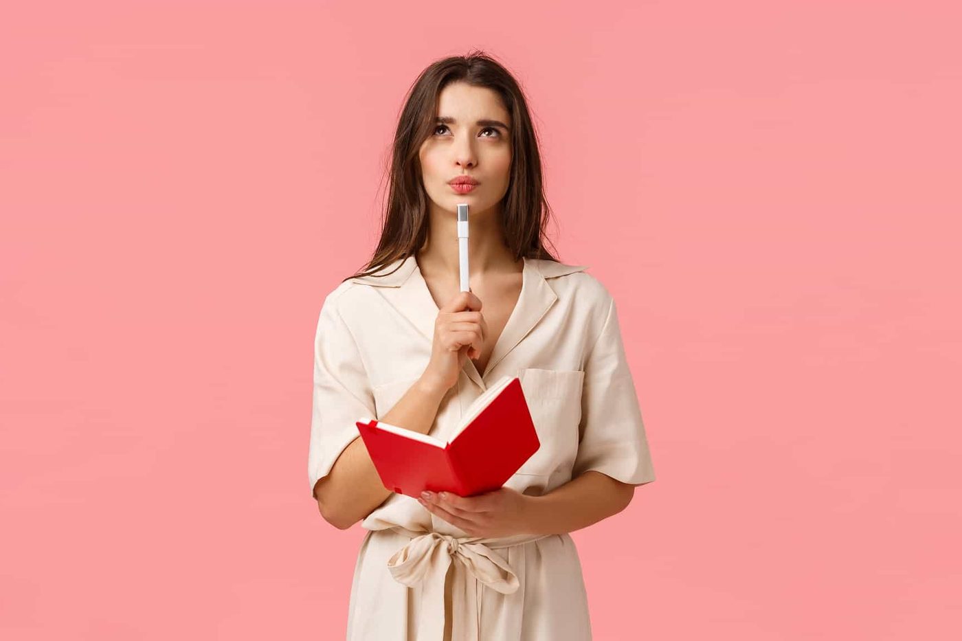 woman think holding notebook