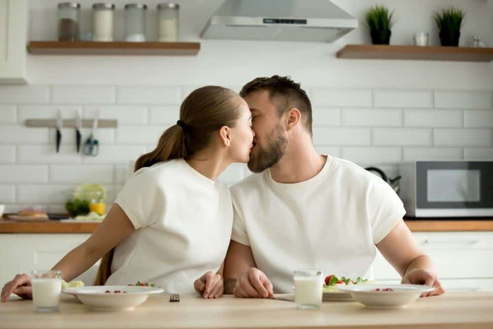 couple kissing in the kitchen
