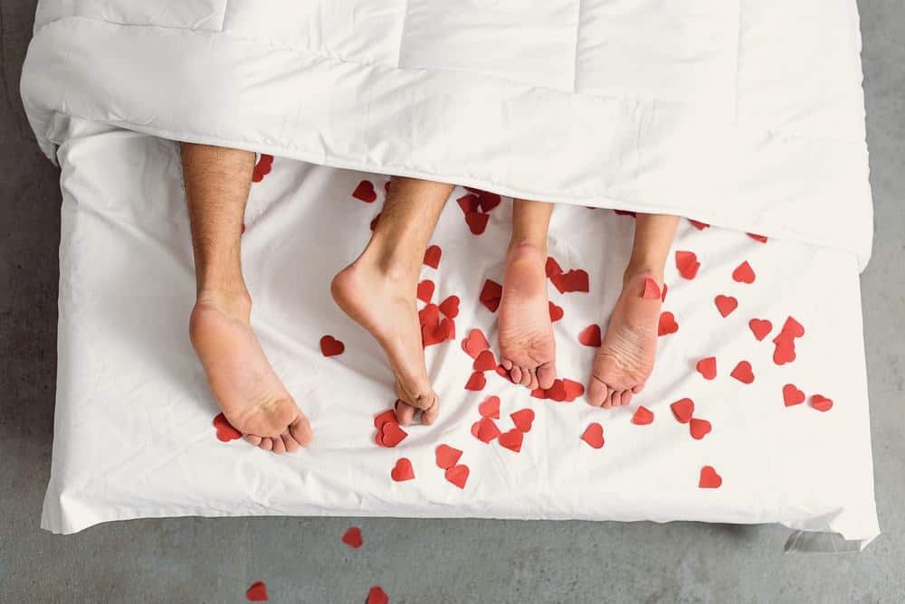 couple in bed with hearts