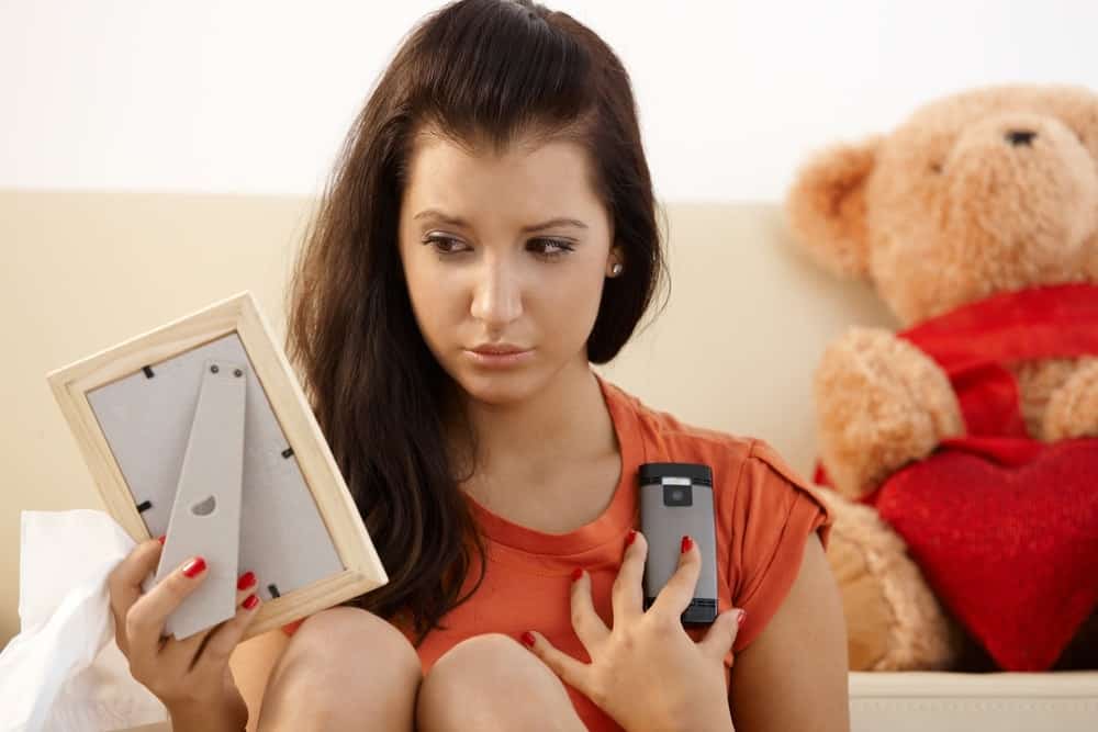 woman looking at a picture of an ex boyfriend