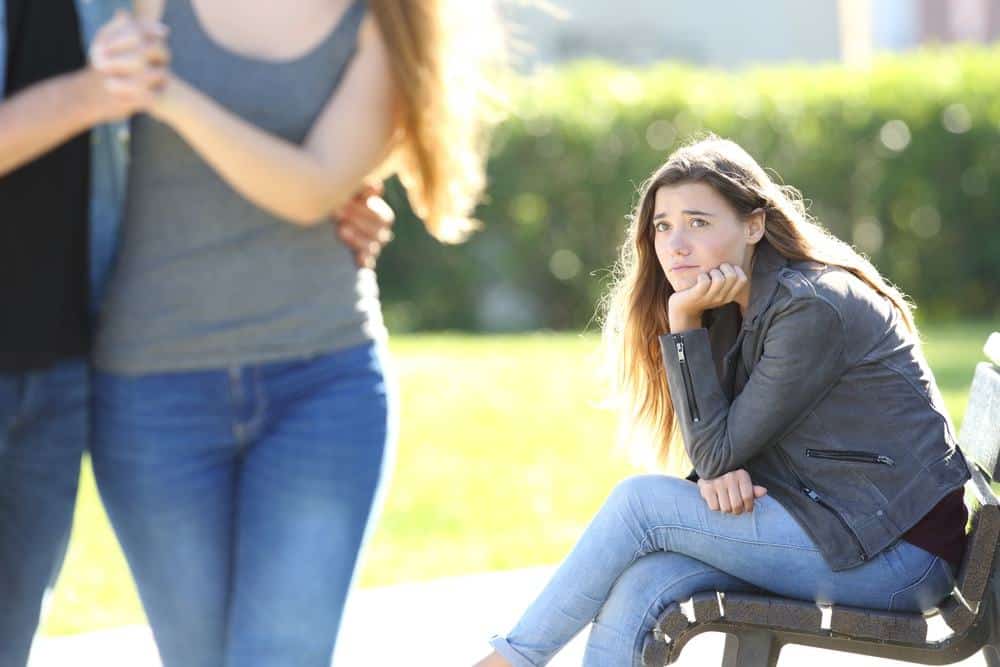 woman jealousy look on a couple