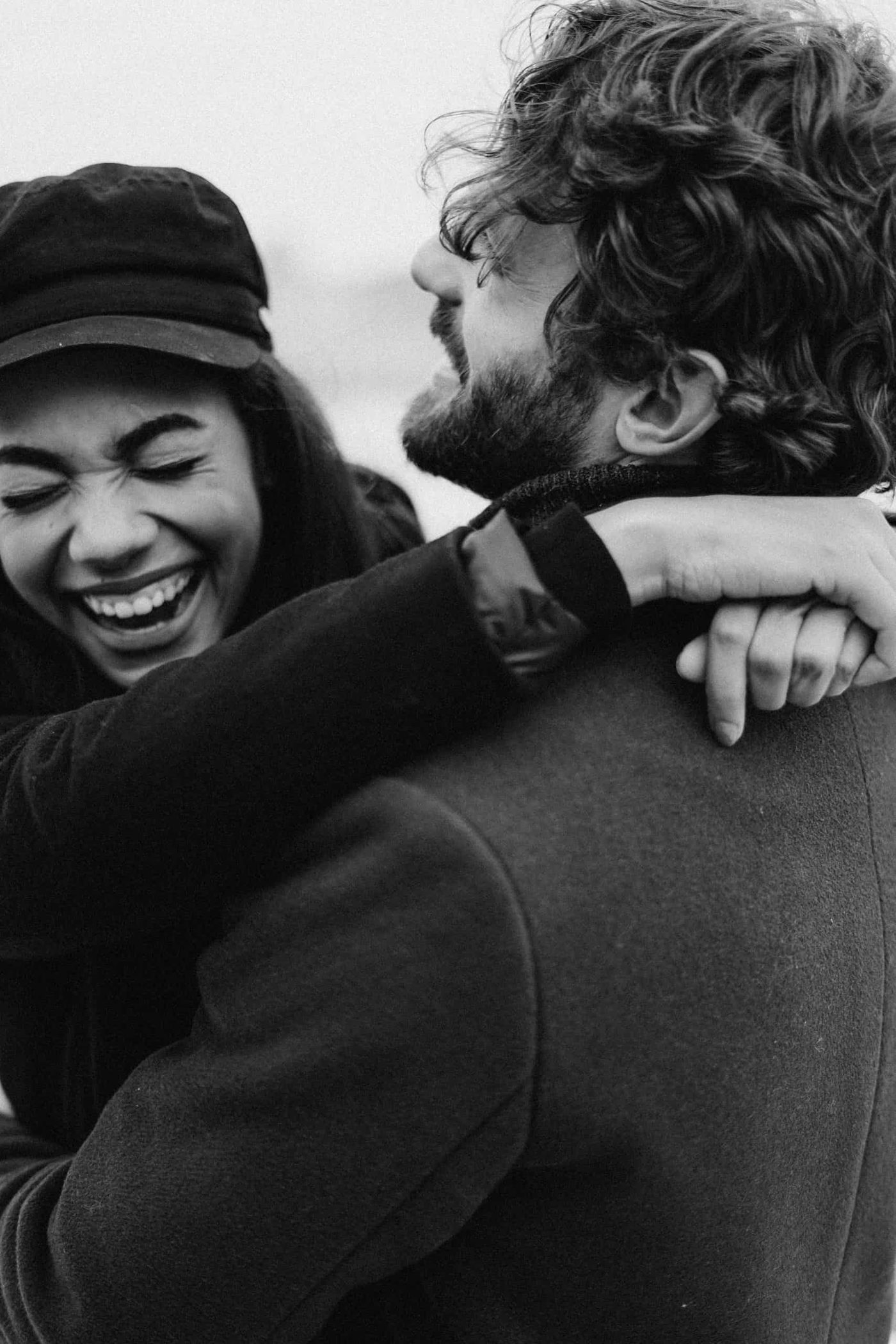 couple laughing and holding each other