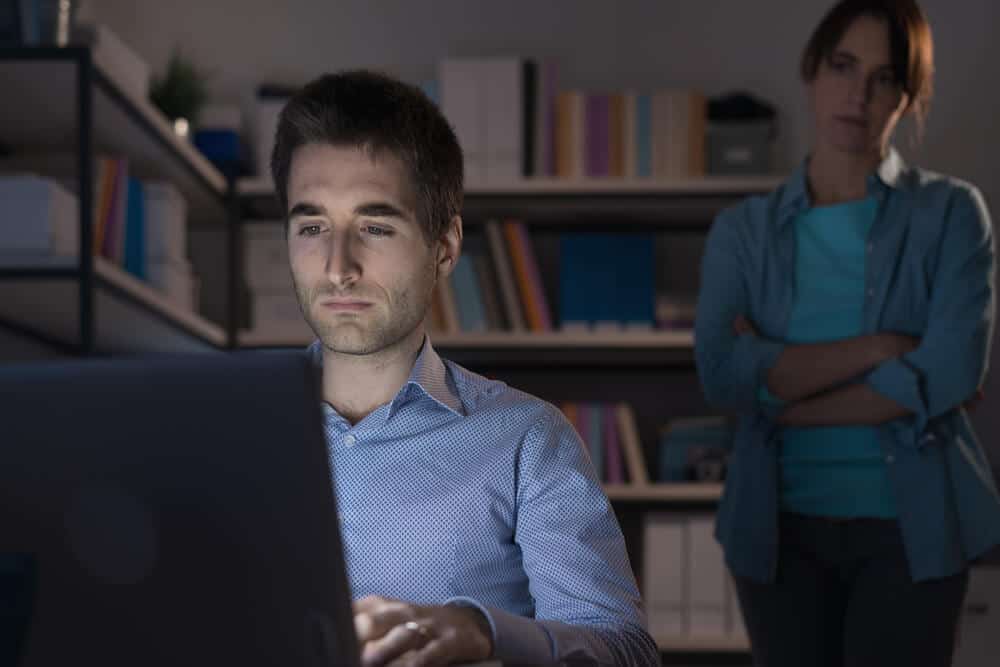 Woman catching man looking on screen