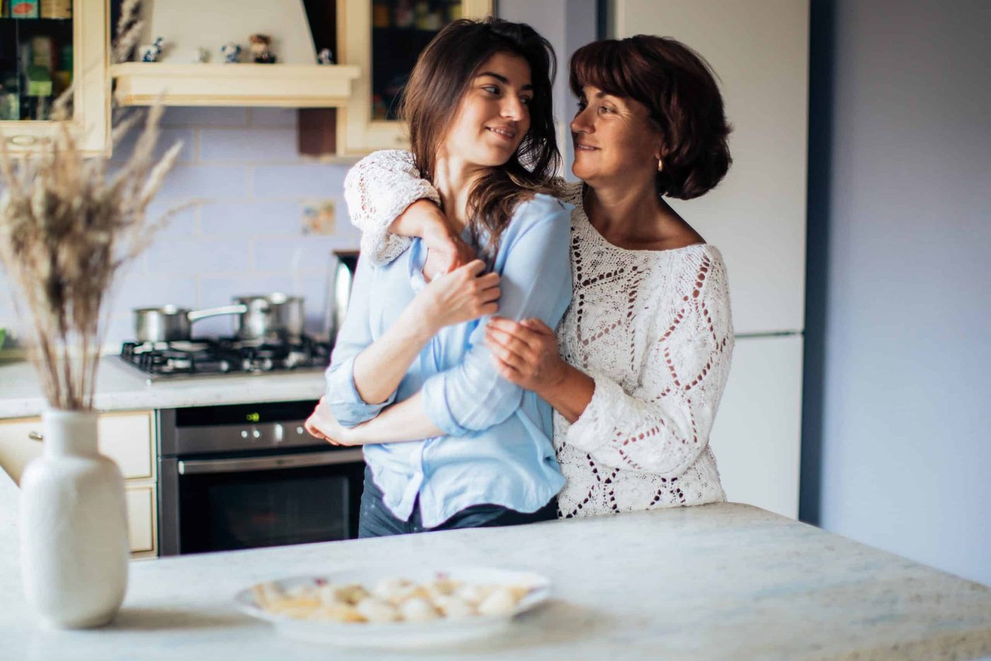Woman and her daughter in law hugging and smiling