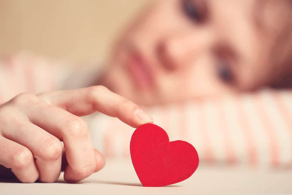 woman in love holding a paper heart