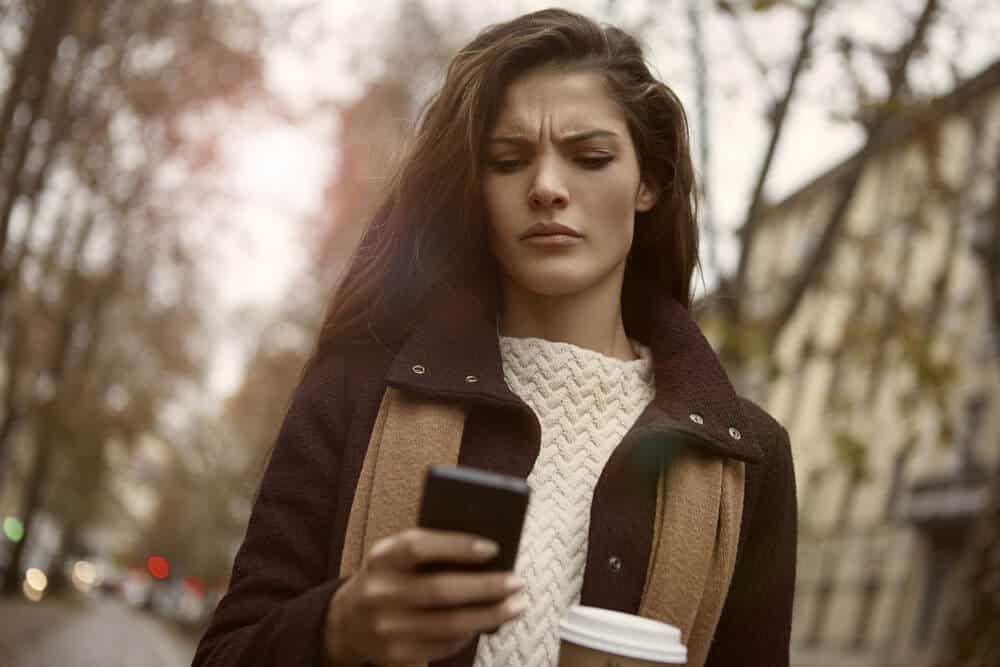 girl looking angrily at the phone