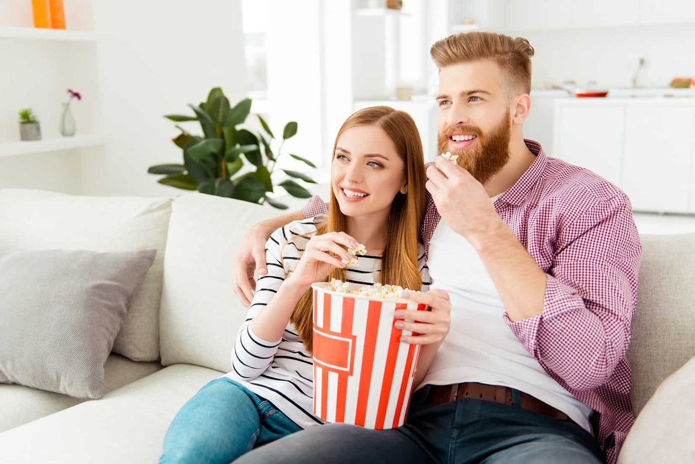 couple sofa popcorn