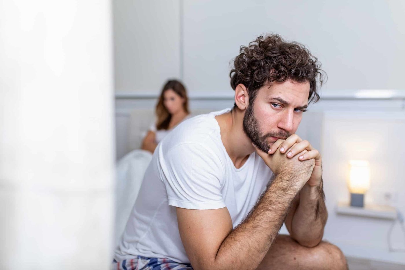 sad man in bed wife