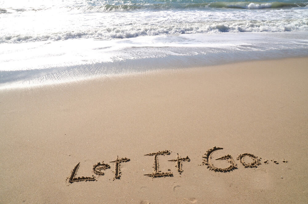 letting go message on sand