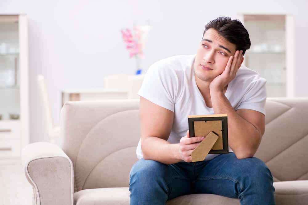 man holding photo thinking