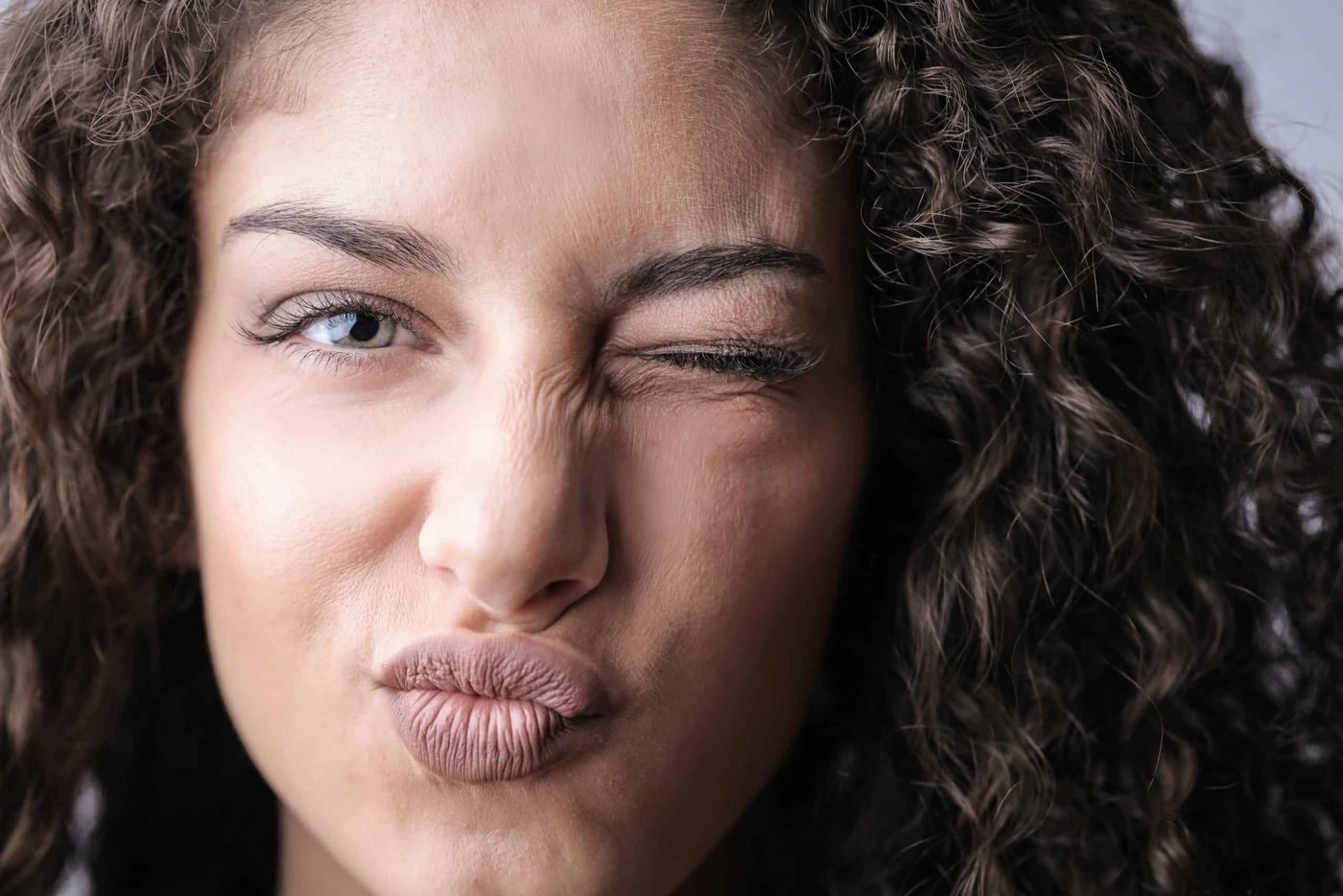 close up of woman winking