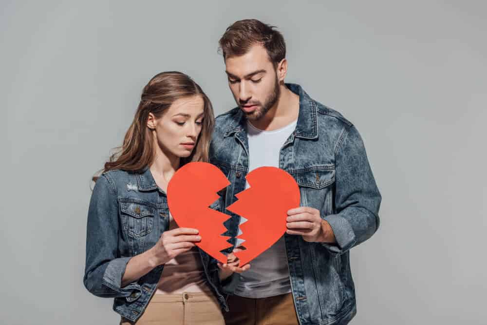 Couple holding broken heart