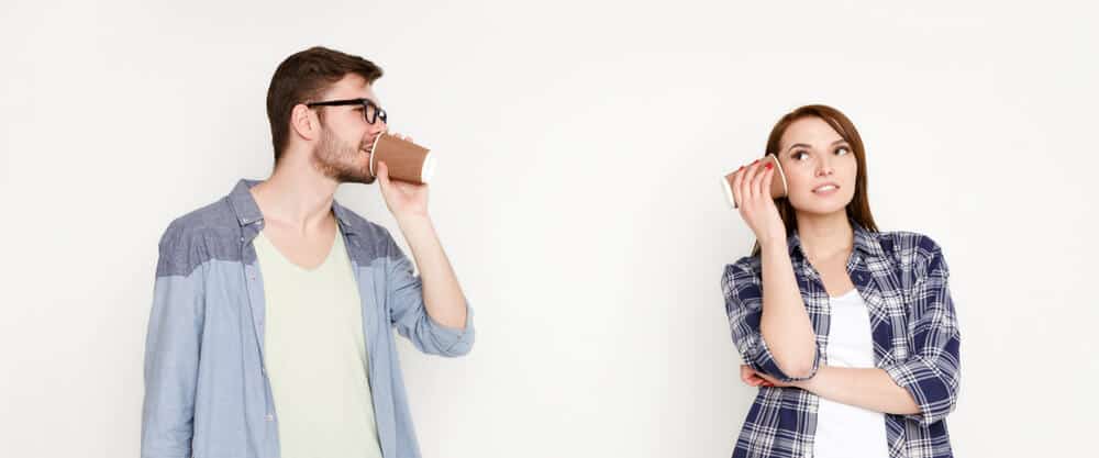 couple communicating by cups