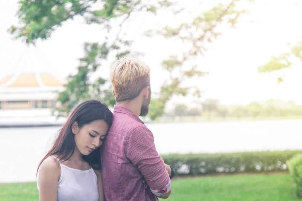 woman disappointed leans on his back