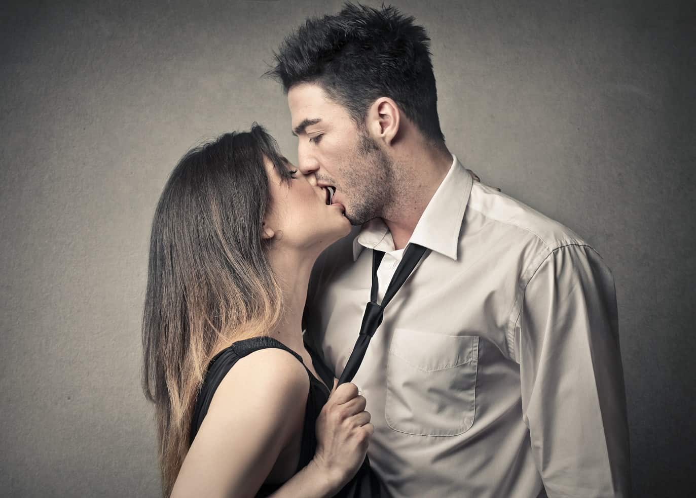 passionate kissing couple grey background