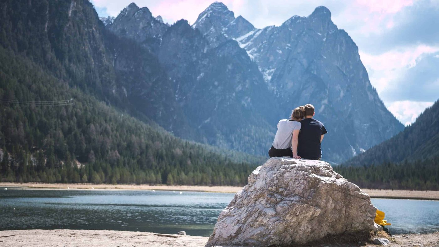 couple sitting on a rock in nature