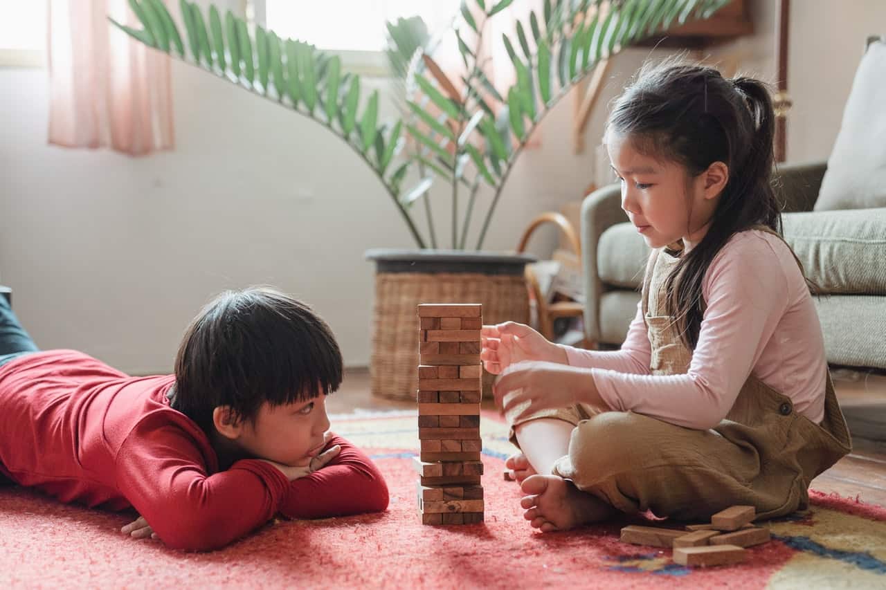 Boy and Girl sitting and playing with building blocks