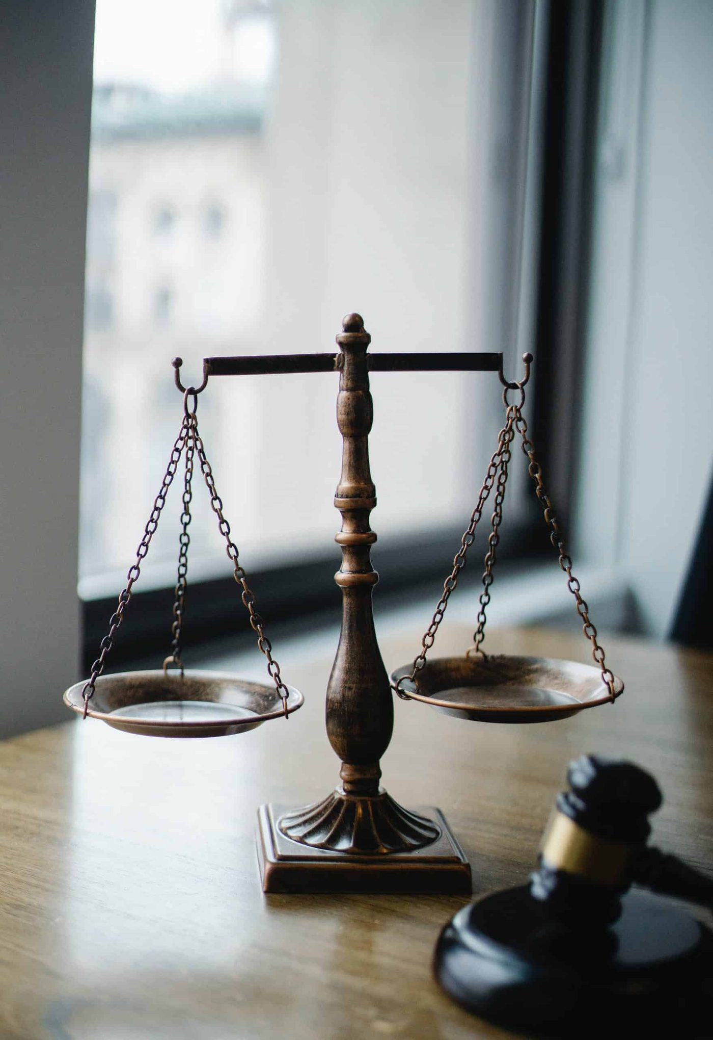 A judge's scale and gavel resting on a table
