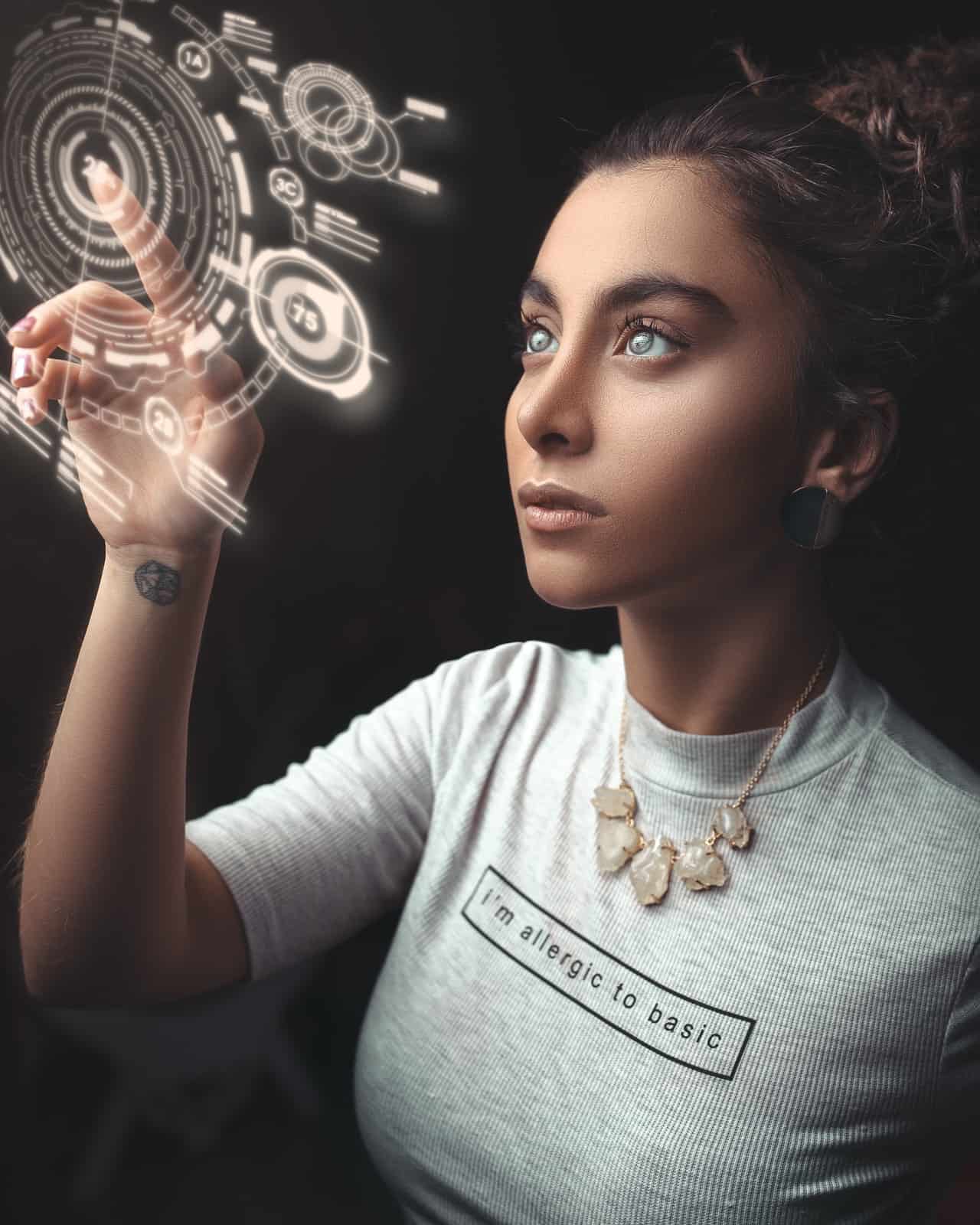 woman looking up and operating a futuristic hologram control
