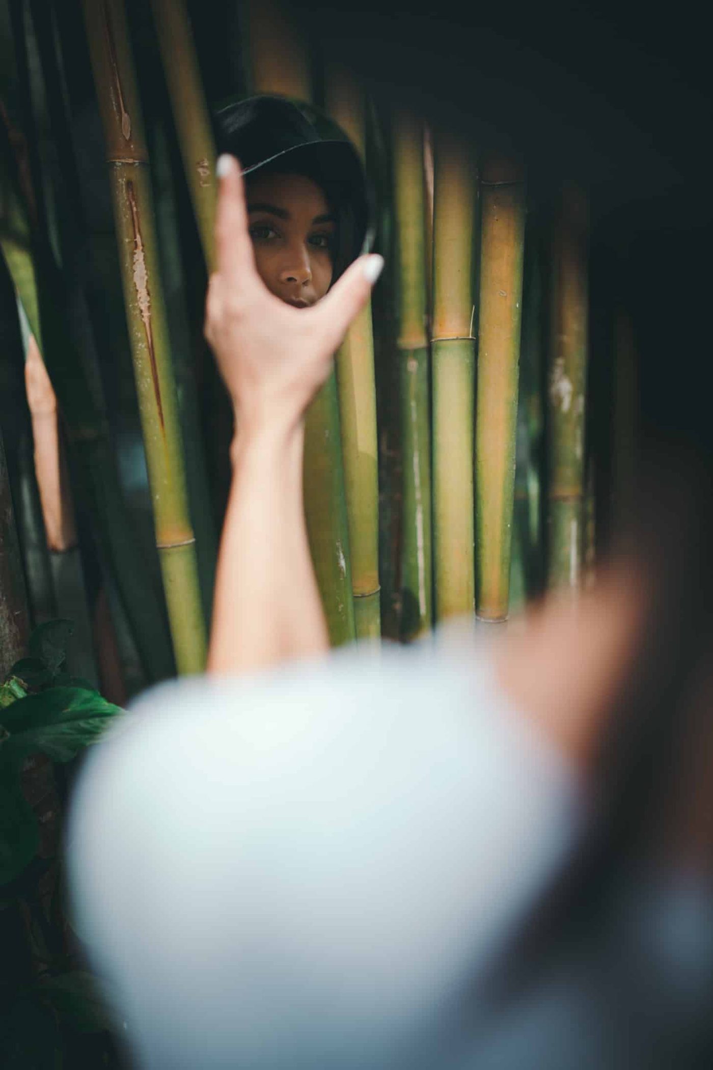 Woman looking at her reflection through a small mirror she is holding