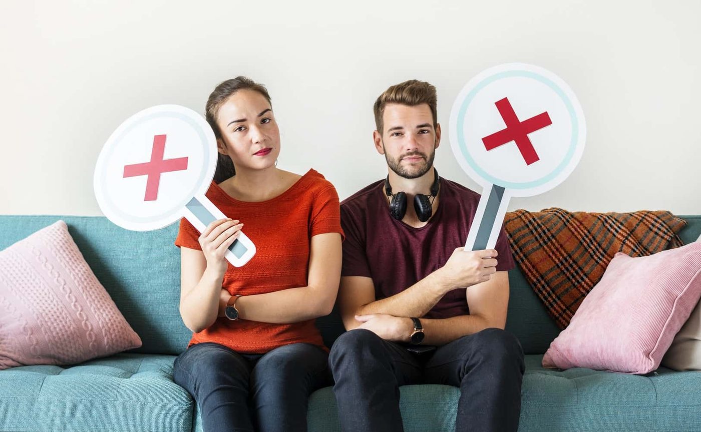couple sitting X signs