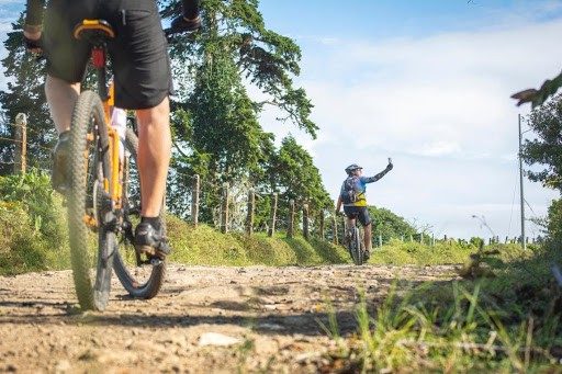 couple cycling together on mountain dirt road
