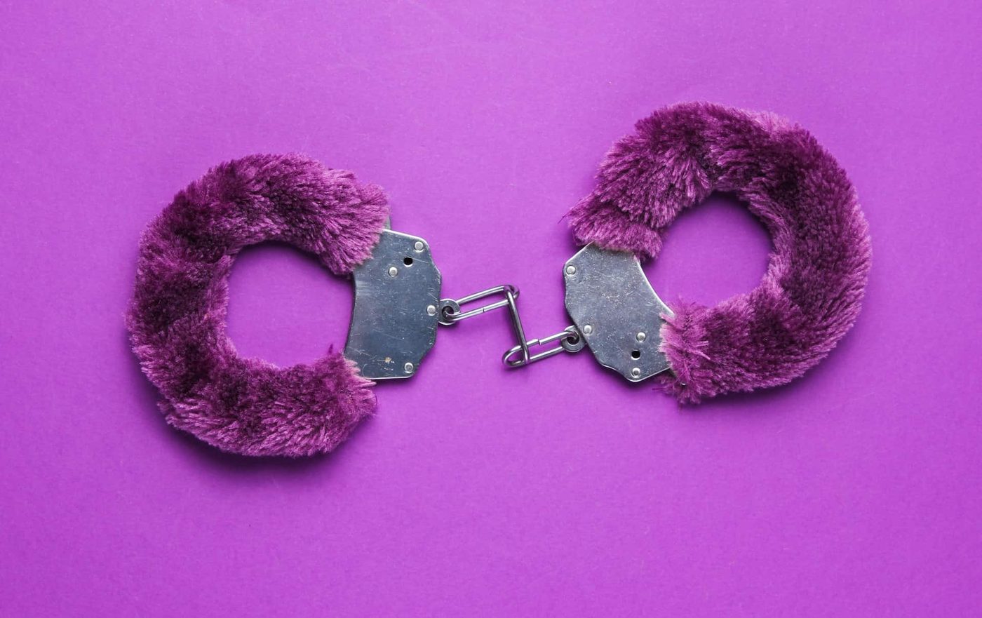 handcuffs for sex games on a purple background