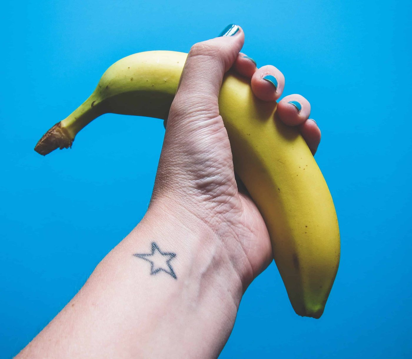 woman hand hold banana tightly