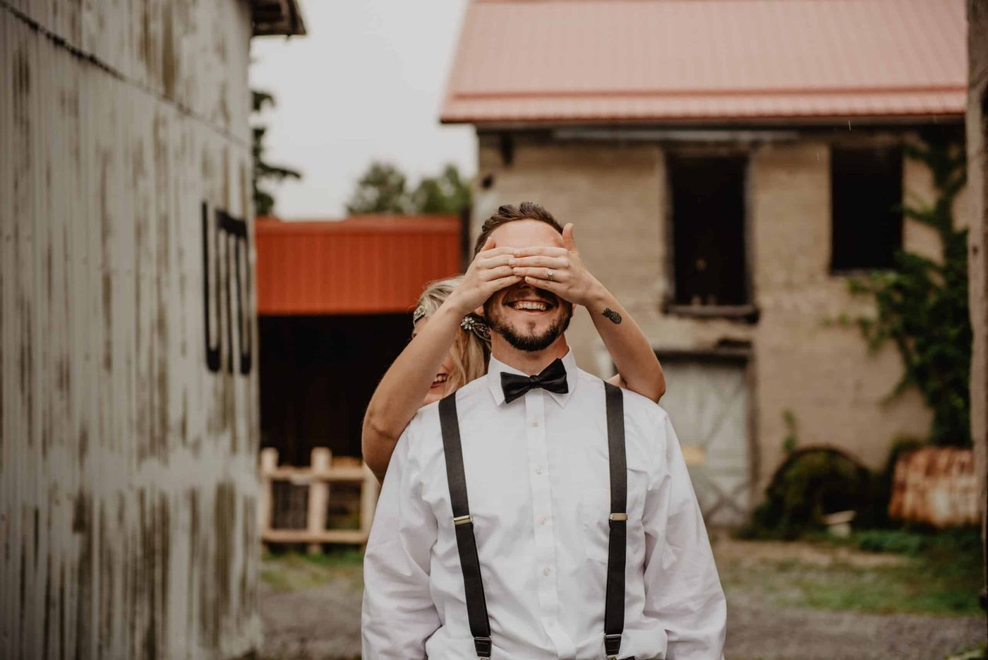 woman covering her mans eyes and surprising him