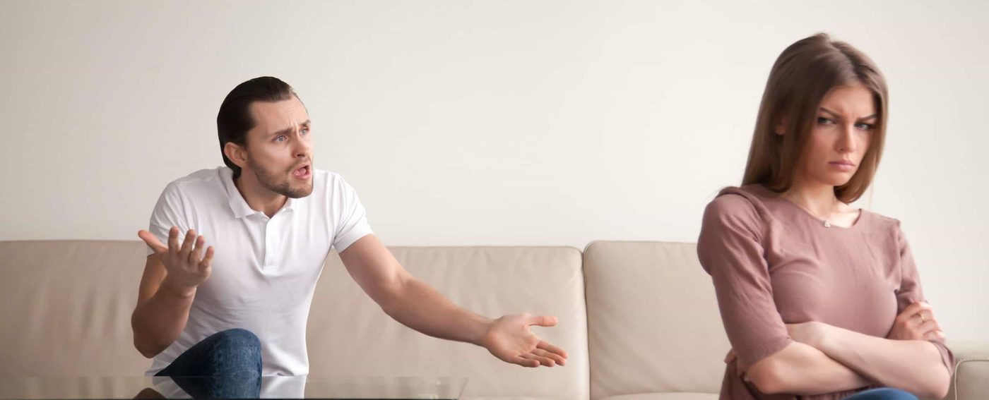 young couple fight on sofa