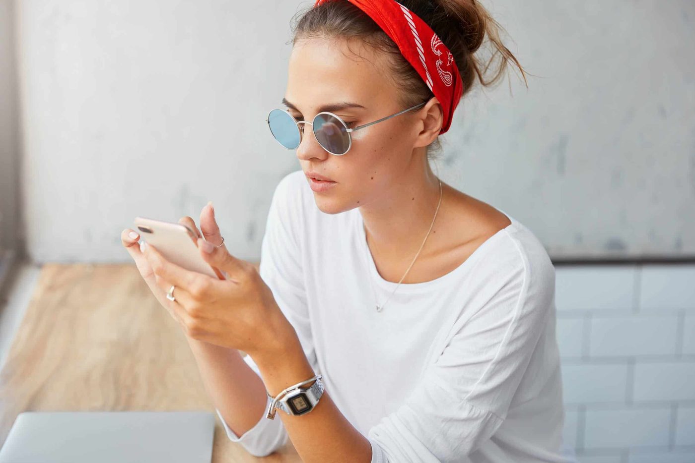 woman on her phone at a coffee shop