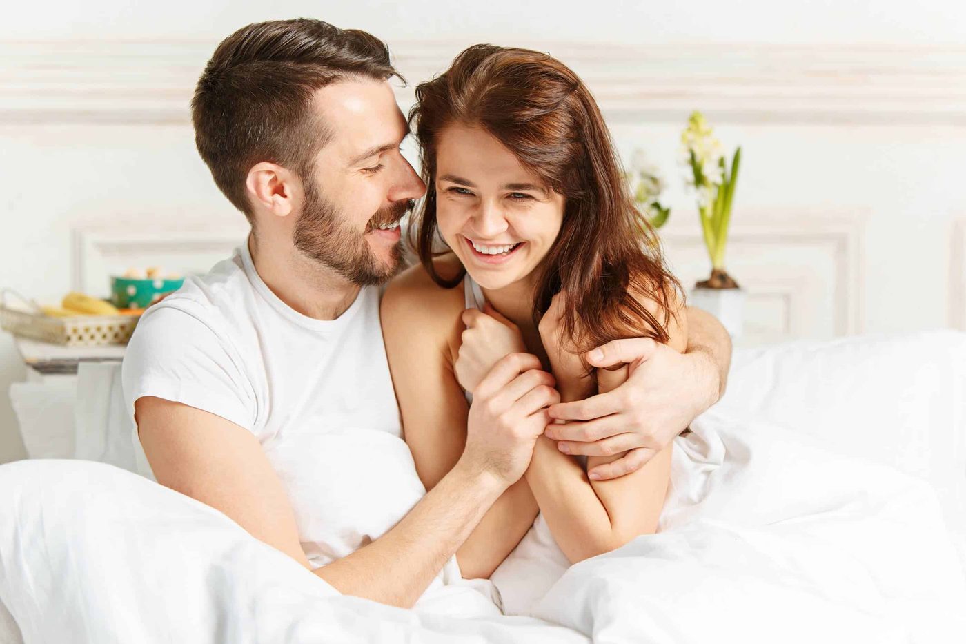 couple happy together in bed at home