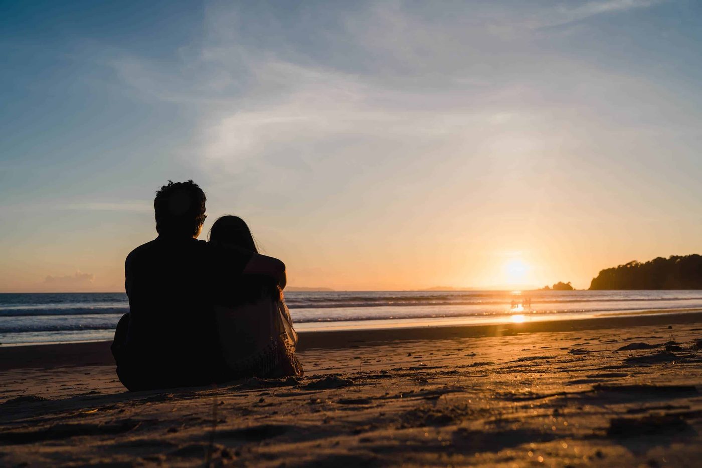 couple hugging in front of sundown